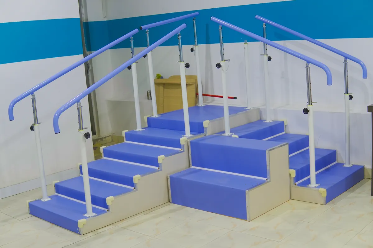 Padded rehabilitation training stairs with adjustable handrails on both sides