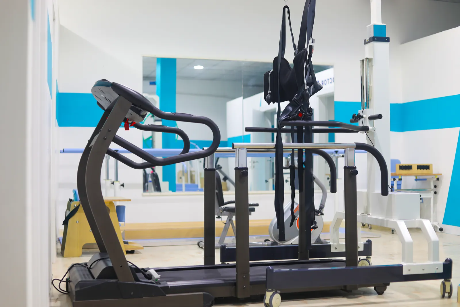The rehabilitation room at Hiraal Clinic, with a treadmill and a harness-supported walking frame